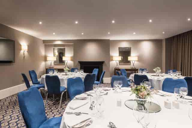 Old Reading Room board meeting with blue seating, ideal for professional corporate events.