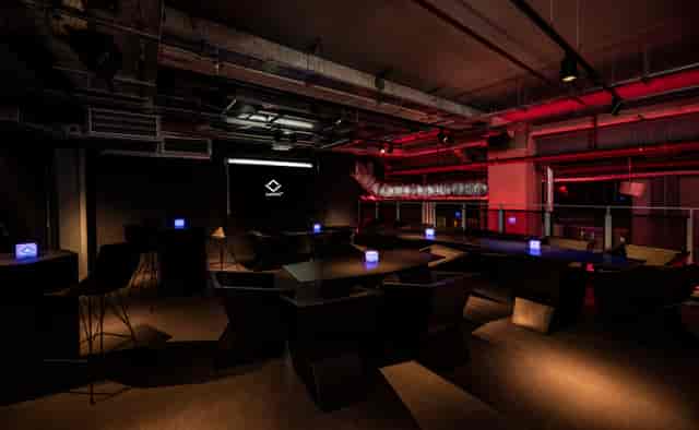 Sandbox VR London mezzanine event space with industrial-chic design for corporate networking.