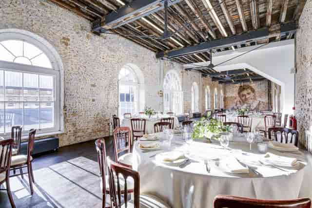 Industrial-chic event space with exposed beams for private functions and banquets.