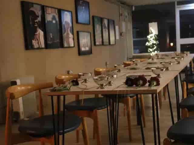 Minimalist gallery-style private dinner setup at Orchard Gardens Community Centre, event workshop.