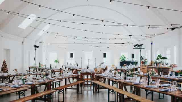 Upstairs banquet room at Orchard Gardens with bench seating for community events and venue hire.