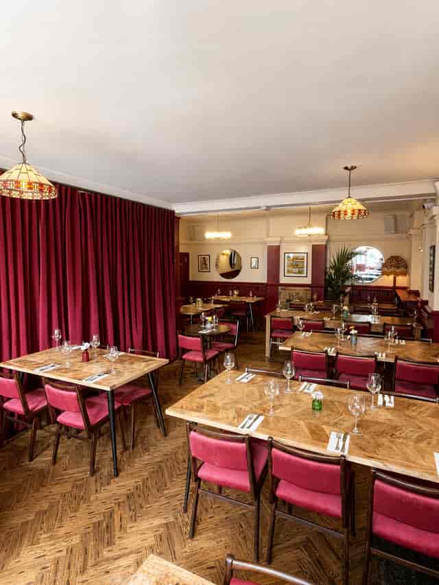 Semi-private dining area with modular tables for corporate receptions and team lunches.