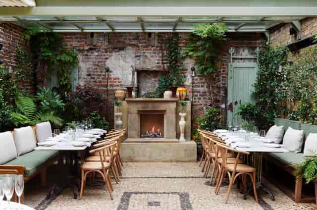 The Conservatory private dining room with fireplace for upscale corporate event or intimate dinner.