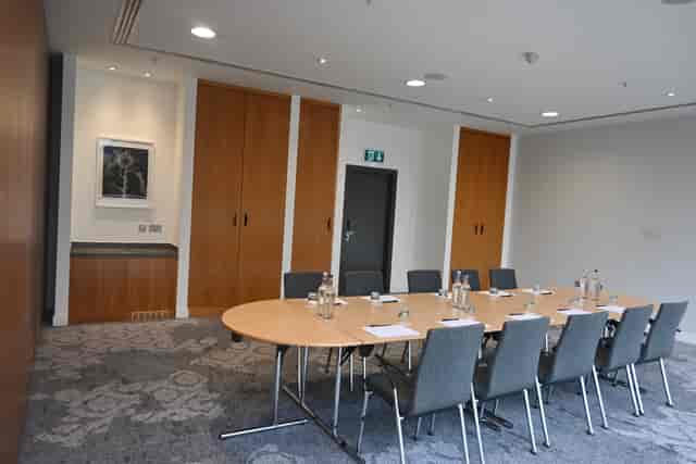 Boardroom meeting room with modular tables for professional breakout sessions and events.