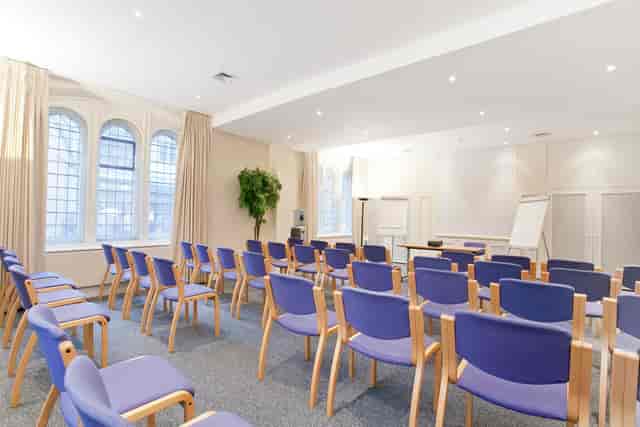 Trevelyan Hall meeting room with purple chairs, ideal for workshops and presentations.