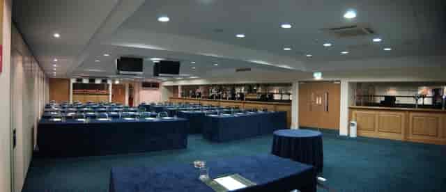 Horseshoe Suite at Haydock Park: professional meeting room with dark blue tables for events.