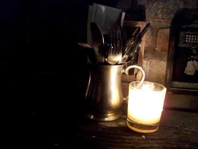 Rustic Old Bailey Bar with candlelight, perfect for intimate gatherings and events.