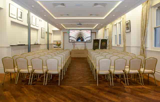 Memorial Hall meeting space with beige chairs, ideal for corporate events and seminars.