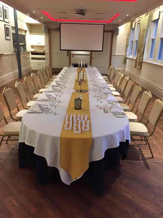 Elegant banquet table with gold runner for formal events and corporate dinners.