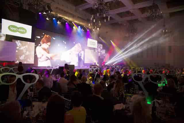 Vibrant corporate event at 8 Northumberland Avenue with engaging presentation and colorful lights.