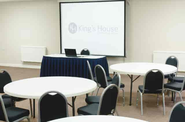Seminar Room 3/4 at King's House: round tables for workshops and small conferences.