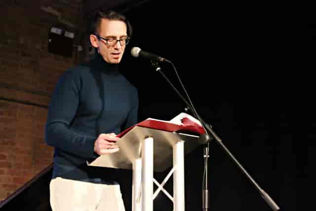 Speaker at podium in The Engine House, engaging audience during a professional event.