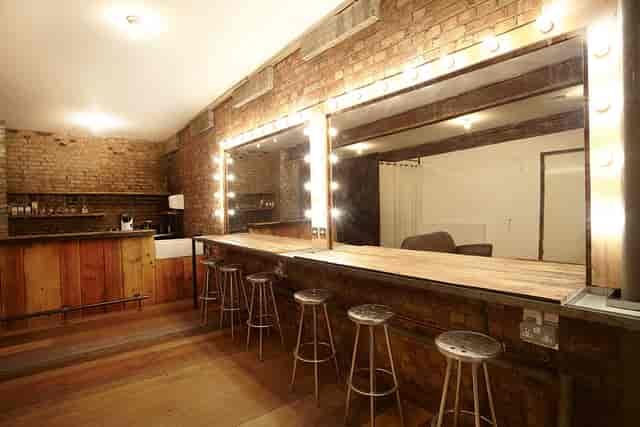 Stylish event space Studio 1 with elegant bar and exposed brick walls at Canvas Works.