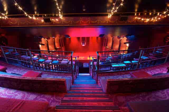 Stylish tiered seating venue with warm lighting for events and gatherings.