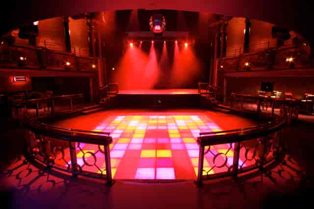 Vibrant event space with colorful dance floor, ideal for corporate events and parties.