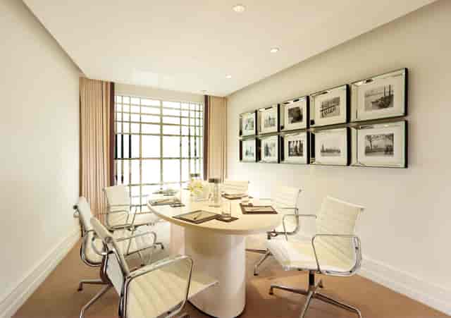 Modern meeting room at The Dorchester with round table for collaborative sessions.
