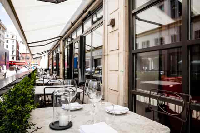 Outdoor dining space at Sartoria, featuring elegant table settings for networking events.
