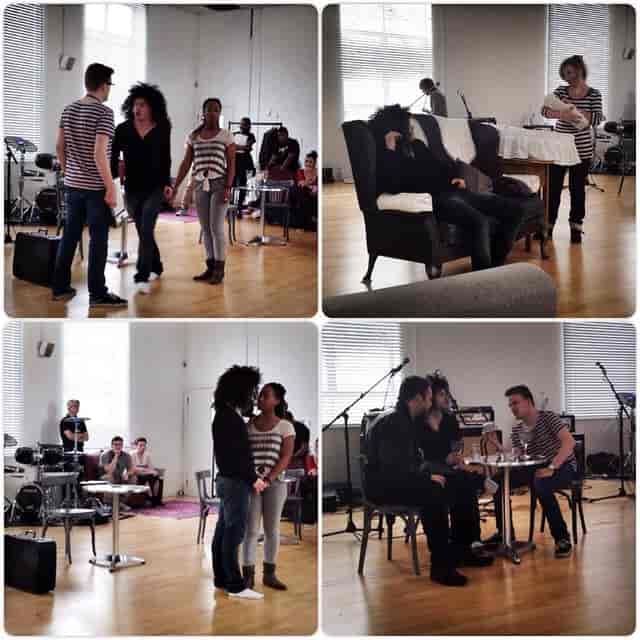 Dynamic rehearsal space at Price Studios with performers, musicians, and flexible seating.