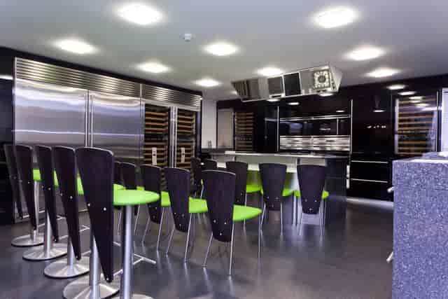 Modern kitchen with stainless steel appliances for cooking classes and culinary events.