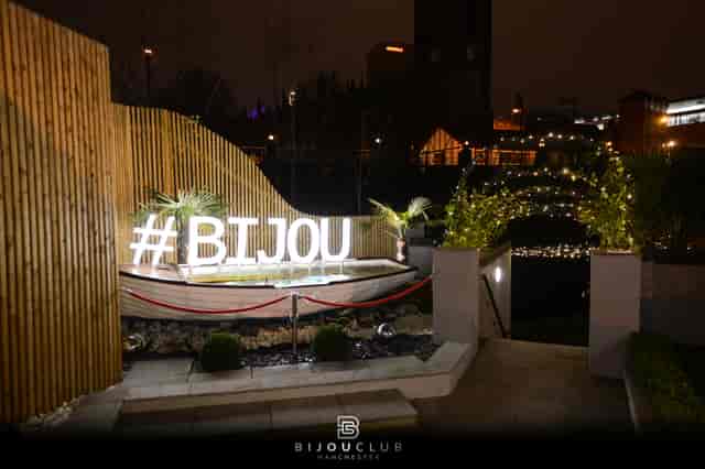 Elegant outdoor cocktail bar with neon signage, perfect for upscale events and nightlife.