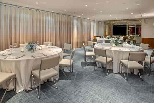 Beaufort Room at Bluebird Chelsea: elegant meeting space with floral centerpieces.