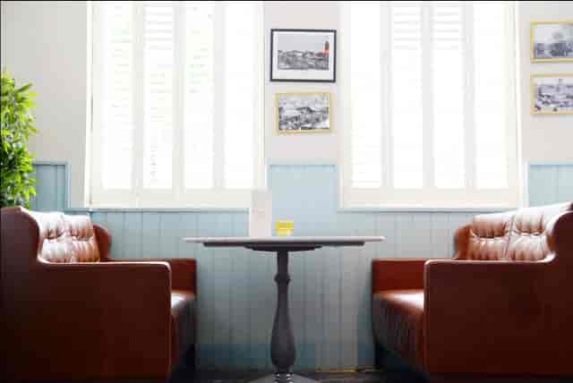Cozy leather sofa meeting space in The Chapel Bar for casual gatherings and brainstorming.