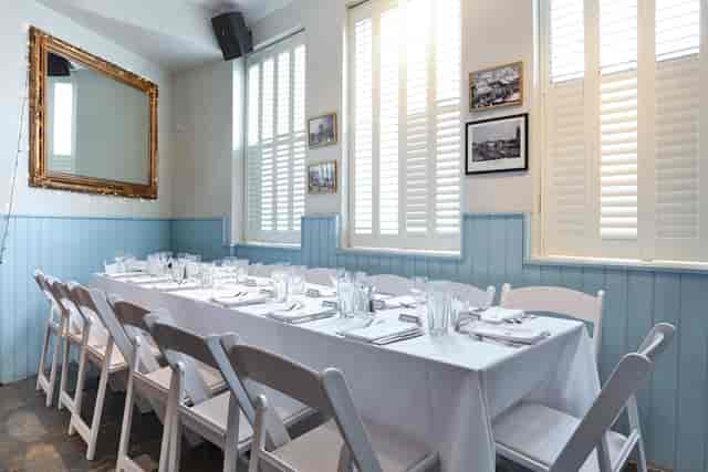Elegant dining setup in The Saloon, ideal for intimate meetings and events.