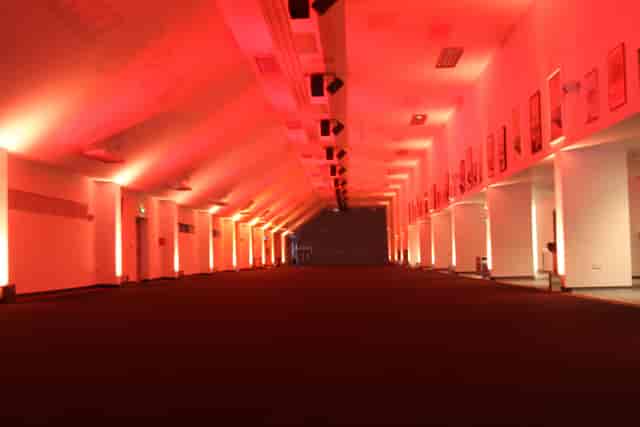 Spacious Olympic Bar at StoneX Stadium, ideal for events with dramatic red lighting.