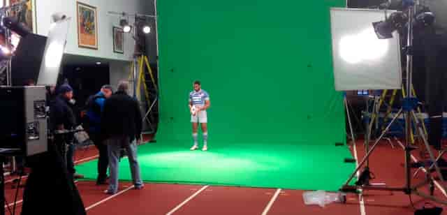 Model in sports attire at The Olympic Bar, StoneX Stadium for event marketing photoshoot.
