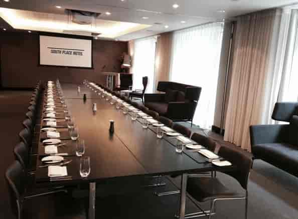 Formal meeting room at South Place Hotel with a long table, ideal for events.