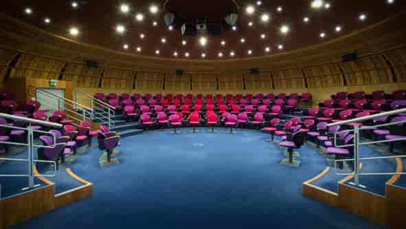 Modern auditorium with tiered seating, ideal for conferences and workshops.