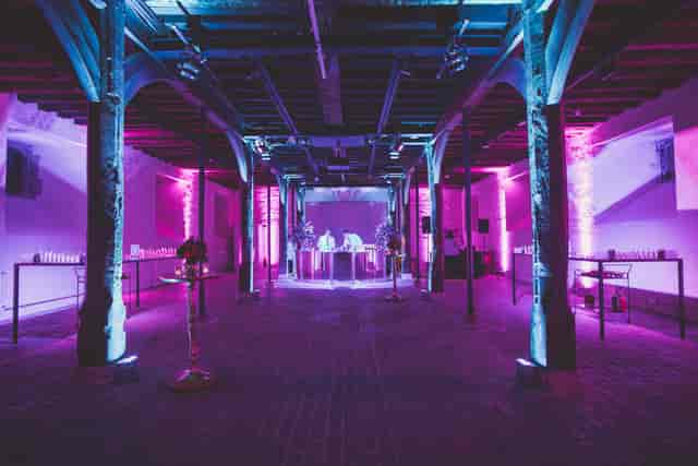 State Apartments at Hampton Court Palace with vibrant purple lighting for events.