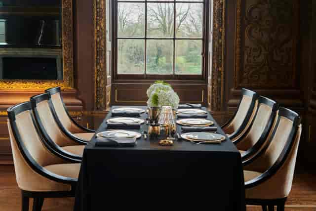 Little Banqueting House dining table with floral centerpiece, ideal for corporate events.