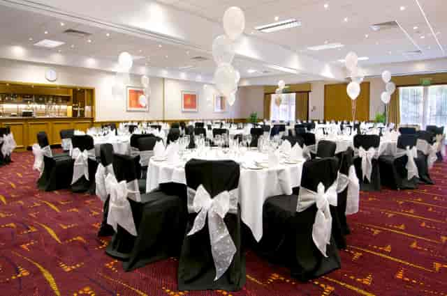 Schiphol Suite banquet setup at Hilton Manchester Airport with elegant tables and balloons.