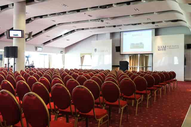 Sunloch Suite conference room with red chairs, ideal for corporate events and presentations.