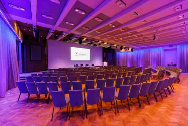 Great Hall at One Moorgate Place, purple-lit conference room for events and presentations.