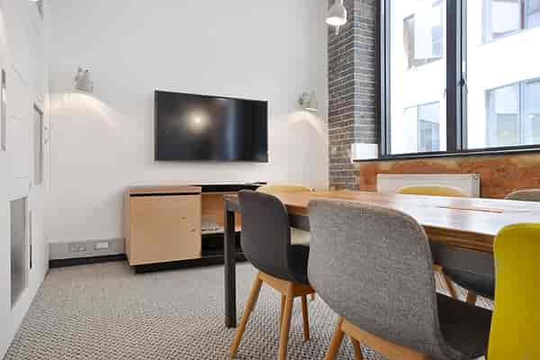 Modern meeting room with colorful chairs, ideal for collaborative events and presentations.