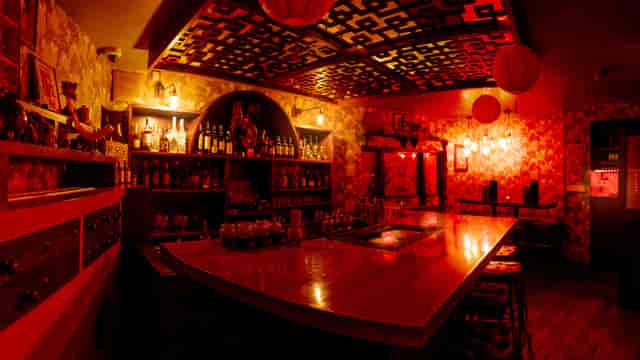 Peony Bar at Opium: vibrant wooden bar, perfect for networking events and themed parties.