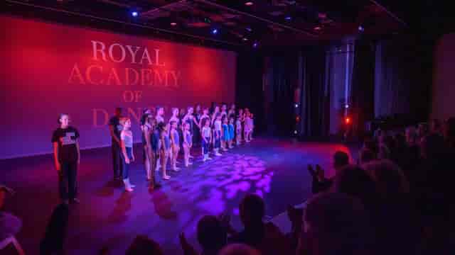 Aud Jebsen Studio Theatre with dancers performing for an engaged audience at a vibrant event.