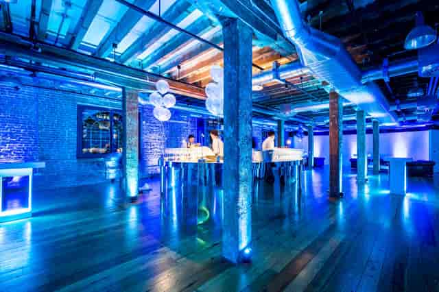 Modern event space at Rum Store, London Docklands, with vibrant blue lighting for gatherings.