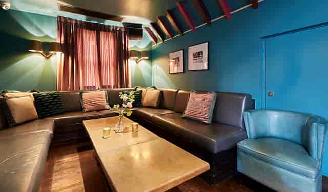 Cozy Penthouse Champagne Bar with plush seating for intimate gatherings and meetings.