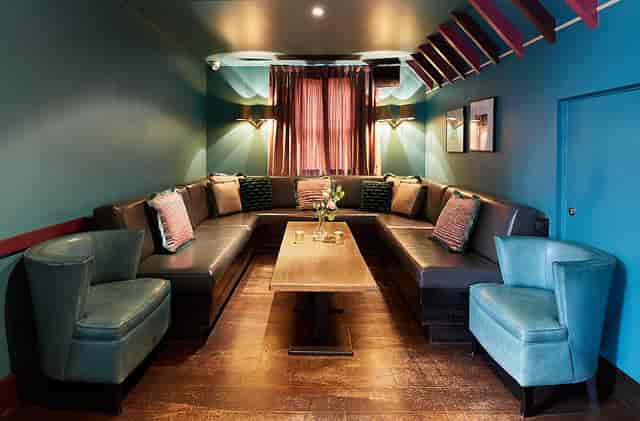 Penthouse Champagne Bar at Beaufort House, cozy seating for intimate meetings and events.