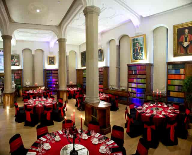 Elegant event space at Christie's Bistro with red tablecloths, ideal for upscale gatherings.