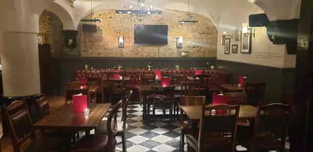 Cozy Marthas Cellar Bar with wooden seating, perfect for intimate gatherings and events.