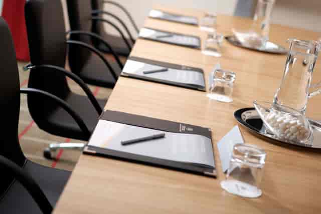 Quayside suite meeting setup at Hilton London Canary Wharf with polished wooden table.