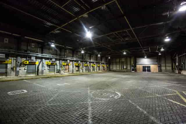 Spacious industrial venue with high ceilings for trade shows and corporate events in London.