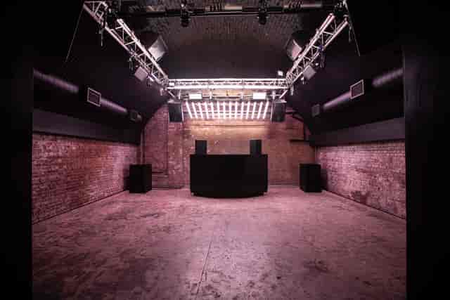 Versatile event space at Ministry of Sound with exposed brick, ideal for concerts and corporate events.