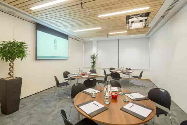 Modern meeting room with round tables, ideal for corporate events and presentations.