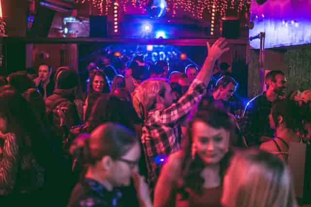 Vibrant event venue at The Big Chill with dynamic lighting and lively crowd.