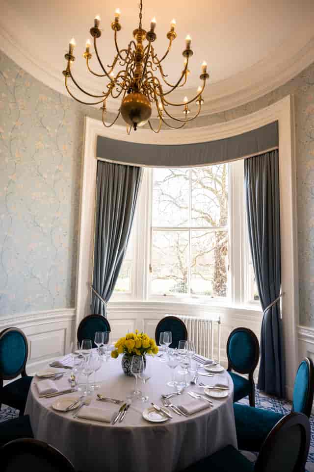 Elegant meeting room with natural light, ideal for small group discussions and events.